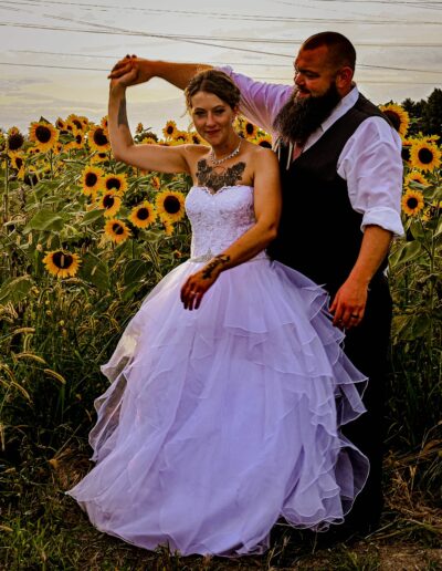 Wedding photo in the Sunflower Field at The Barn at Honey Blossom Orchard. Wedding and Event Venue in Northwest Ohio