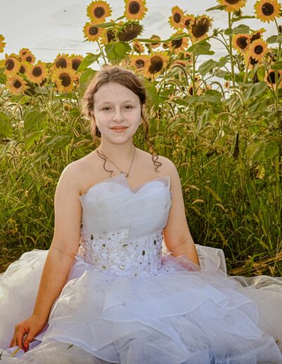 Bridesmaid photo in the Sunflower field at Honey Blossom ORchard. Wedding and Event Venue in Northwest Ohio.